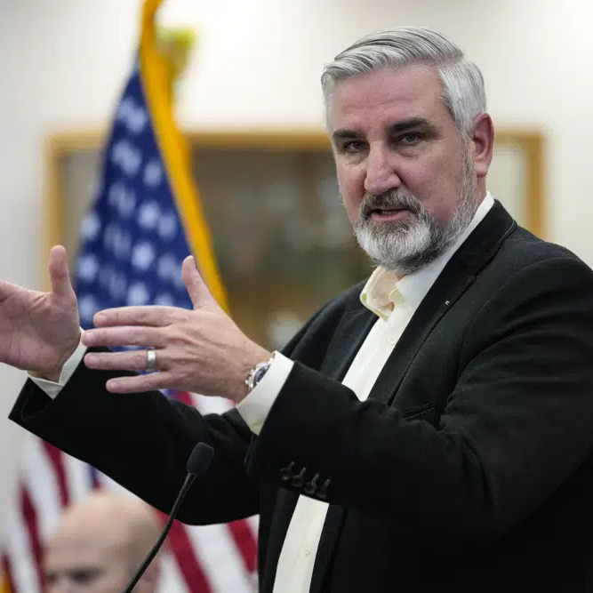 Indiana Governor Eric Holcomb in front of US flag